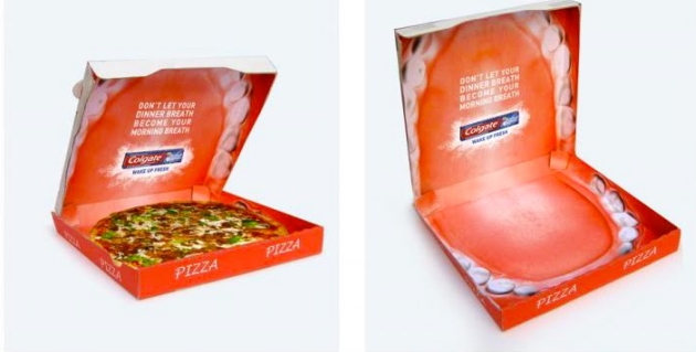 Anúncio da Colgate, com uma boca do lado de dentro de uma caixa de pizza