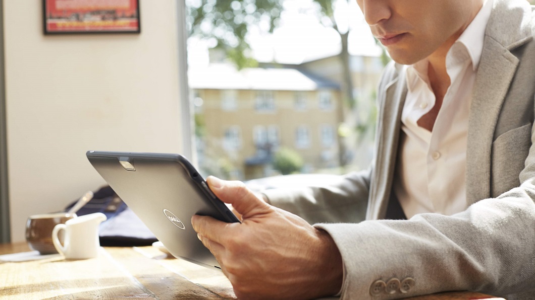 Young Man Using Venue 11 Pro Tablet In A Cafe