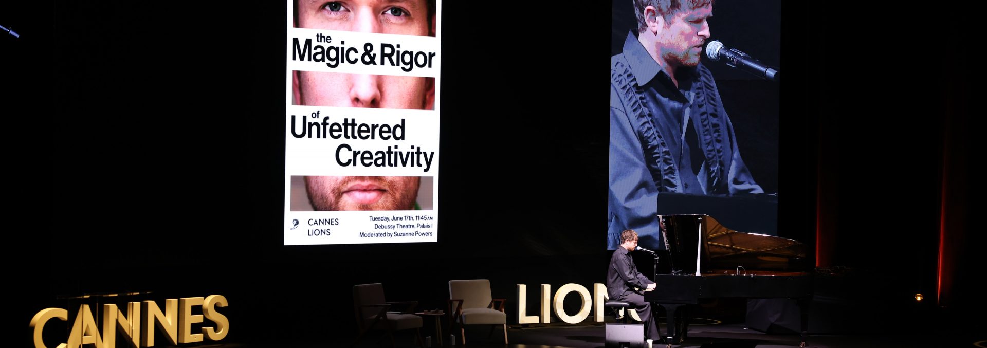 People, Person, Keyboard, Musical Instrument, piano, Cinema, Electrical Device, Microphone, Stage, Crowd, Adult, Male, Man, Chair, Furniture, Electronics, Screen, Computer Hardware, hardware, monitor, face, Head, Audience, Lighting, Concert, Indoors